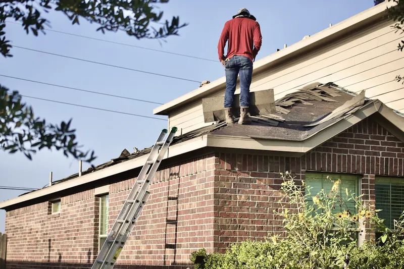 Professional roofer working on a residential roof in Old Evergreen Highway
